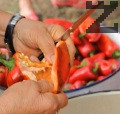 Почистваме и нарязваме чушките и доматите. Поставяме ги в дълбок казан на огъня.