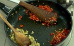 Наситняваме сушения домат и го добавяме към частта с доматите. В друга част на съда поставяме наситнения патладжан, към който прибавяме нарязаната смокиня. Задушаваме компонентите за още няколко минути.