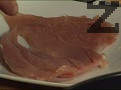 Изтъняваме пилешкото филе, намазваме го с чили сос. Поръсваме с кимион, втриваме добре и от двете страни.