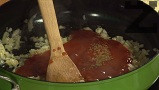 Прибавяме доматеното пюре, поръсваме с кимион, поливаме с чили сос. Разбъркваме, пържим за 1 мин.